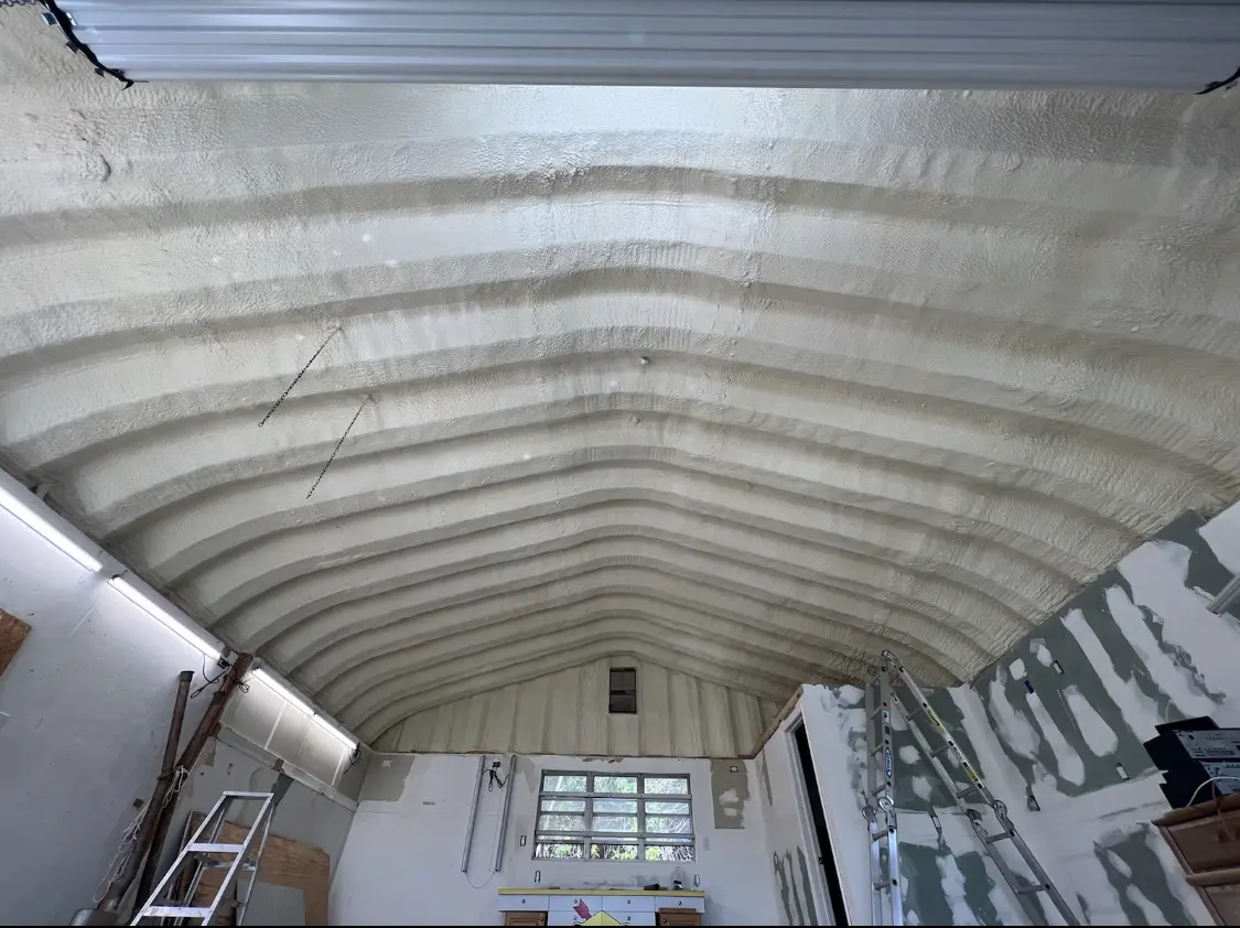 Spray polyurethane foam applied to the underside of a metal roof deck in Groton
